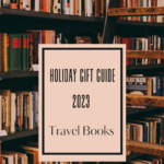 Image of bookshelves in the background and the title holiday gift guide 2023 travel books.