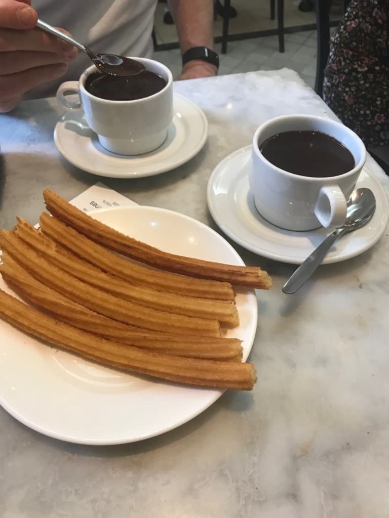 Churros with dark chocolate on the side.