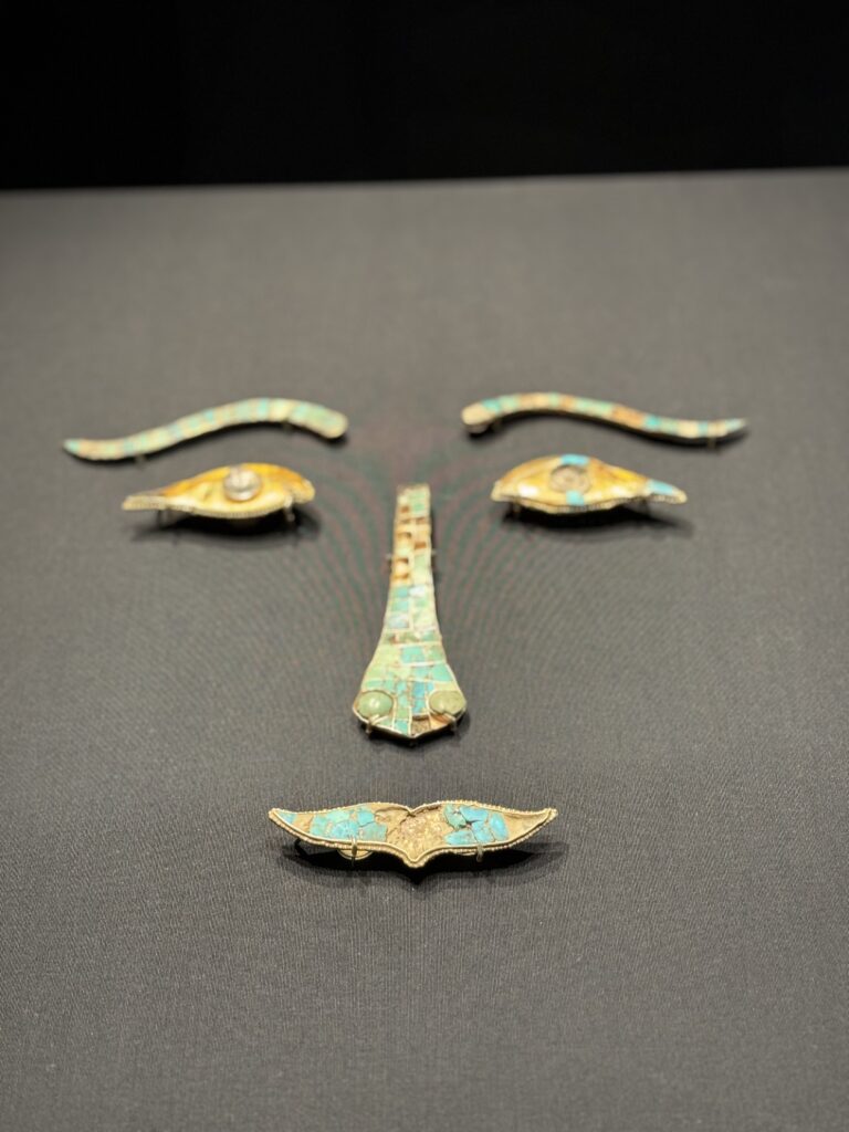 Jewellery placed in the shape of a face depicting eyes, eyebrows, nose, and mouth. Part of the antique collection at the Museum of Art in Hong Kong. Perfect stop on a 5 day itinerary Hong Kong.