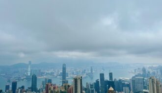 Birds eye-view of the Kowloon and Victoria Harbour skylines. Skyscrapers dot the skylines of Hong Kong.