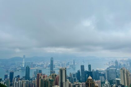 Birds eye-view of the Kowloon and Victoria Harbour skylines. Skyscrapers dot the skylines of Hong Kong.