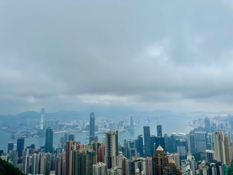 Birds eye-view of the Kowloon and Victoria Harbour skylines. Skyscrapers dot the skylines of Hong Kong. Perfect stop for your one day in hong kong itinerary.