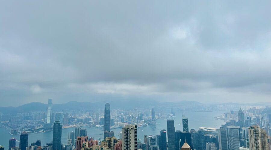 Birds eye-view of the Kowloon and Victoria Harbour skylines. Skyscrapers dot the skylines of Hong Kong.
