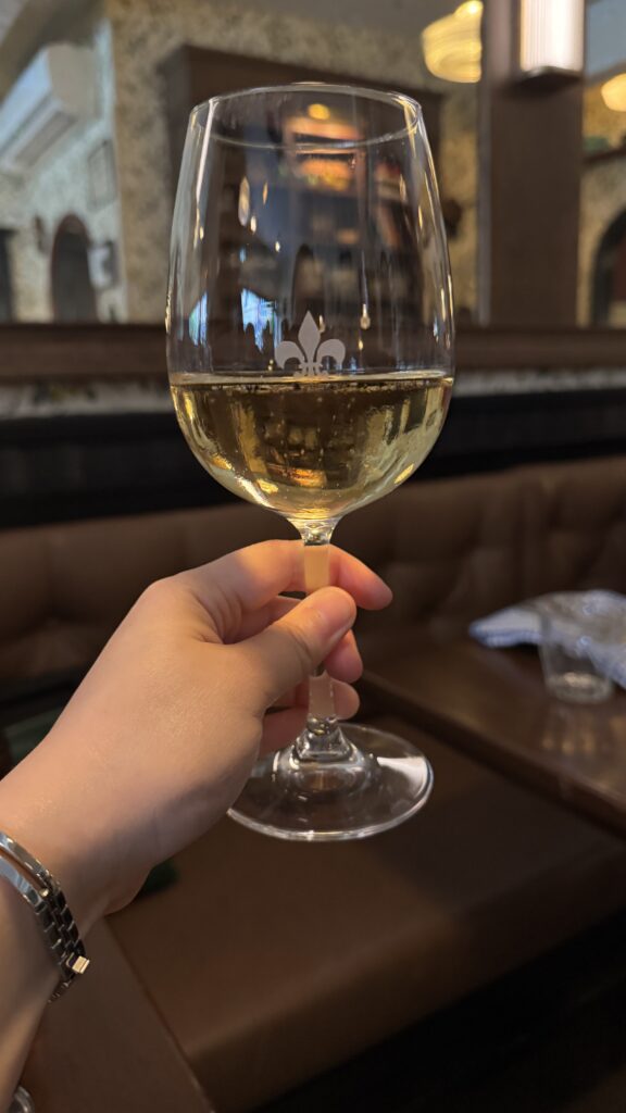 Woman holding wine glass at joe beef at the best place to eat in montreal. 